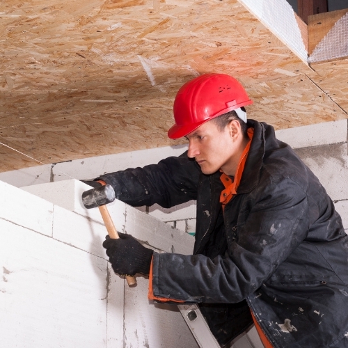 A worker performs masonry work.